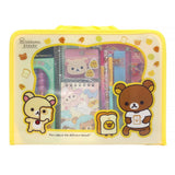 Two officially licensed Rilakkuma and Chairoikoguma stationery sets in clear plastic carry cases with handles. Both cases are packed with notebooks, pencils, and other stationery items.