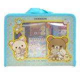 Two officially licensed Rilakkuma and Chairoikoguma stationery sets in clear plastic carry cases with handles. Both cases are packed with notebooks, pencils, and other stationery items.