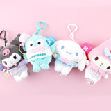 Four Sanrio characters plush keychains on a pink background