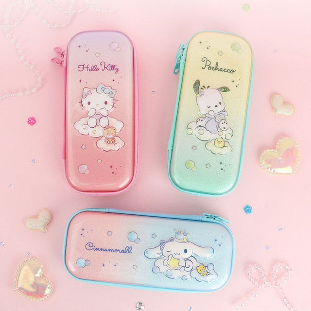 Three officially licensed Sanrio hard shell pencil cases featuring Hello Kitty, Pochacco, and Cinnamoroll on dreamy pastel glitter gradients