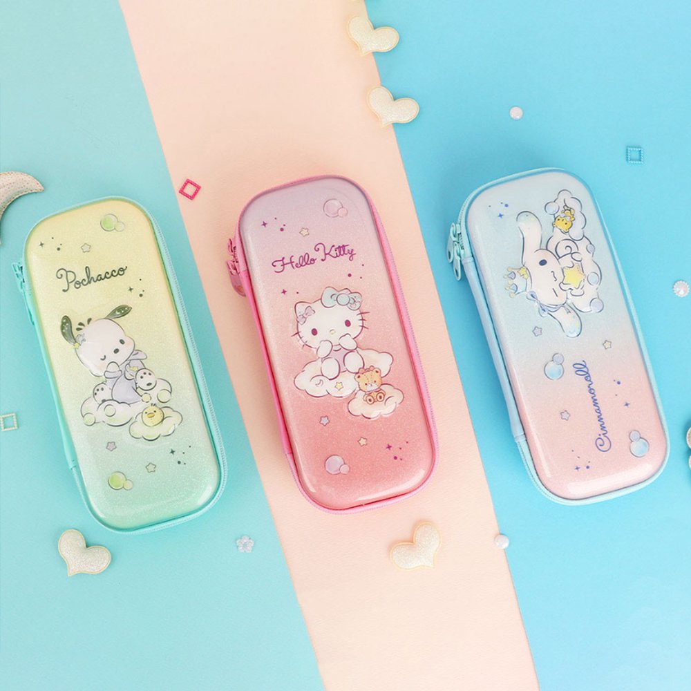 Three officially licensed Sanrio hard shell pencil cases featuring Hello Kitty, Pochacco, and Cinnamoroll on dreamy pastel glitter gradients