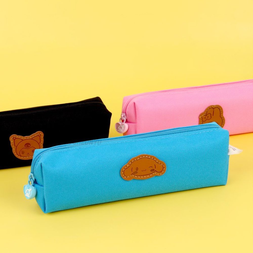 Three officially licensed Sanrio fabric pencil cases featuring stitched faux-leather character patches.