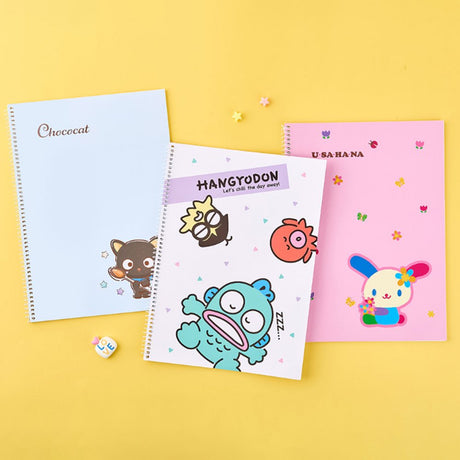 An officially licensed Sanrio three colorful spiral notebooks featuring Chococat, Hangyodon, and Usahana, comes with lined paper and a subtle character illustration in the bottom corner