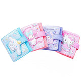 An officially licensed Sanrio collection of tri-fold wallets in pink, purple, and blue featuring large 3D padded appliqués of Hello Kitty, My Melody, Cinnamoroll, and Kuromi