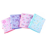 An officially licensed Sanrio collection of tri-fold wallets in pink, purple, and blue featuring large 3D padded appliqués of Hello Kitty, My Melody, Cinnamoroll, and Kuromi