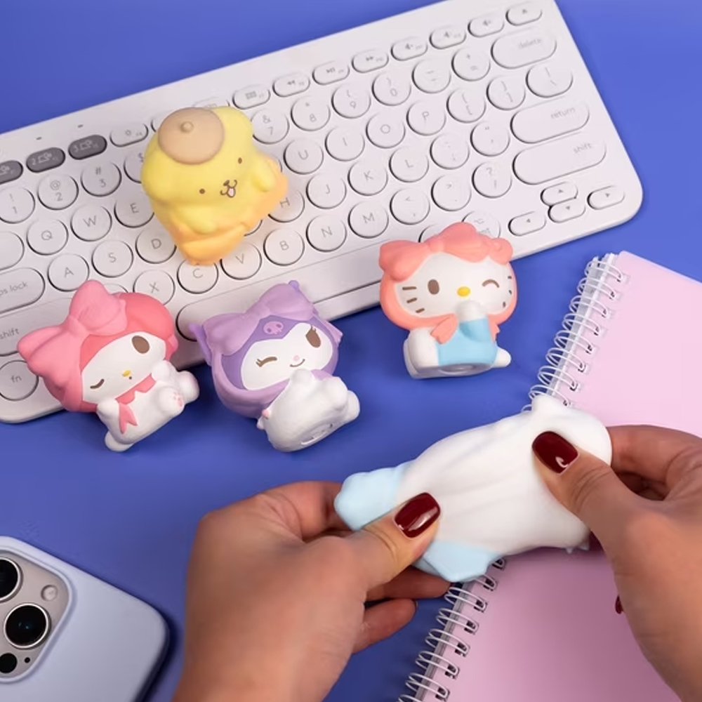 Officially licensed Sanrio Characters Water Squishy Surprise Capsule surrounded by collectible water-filled squishy figures including Hello Kitty, Kuromi, My Melody, Cinnamoroll, and Pompompurin wearing large bows
