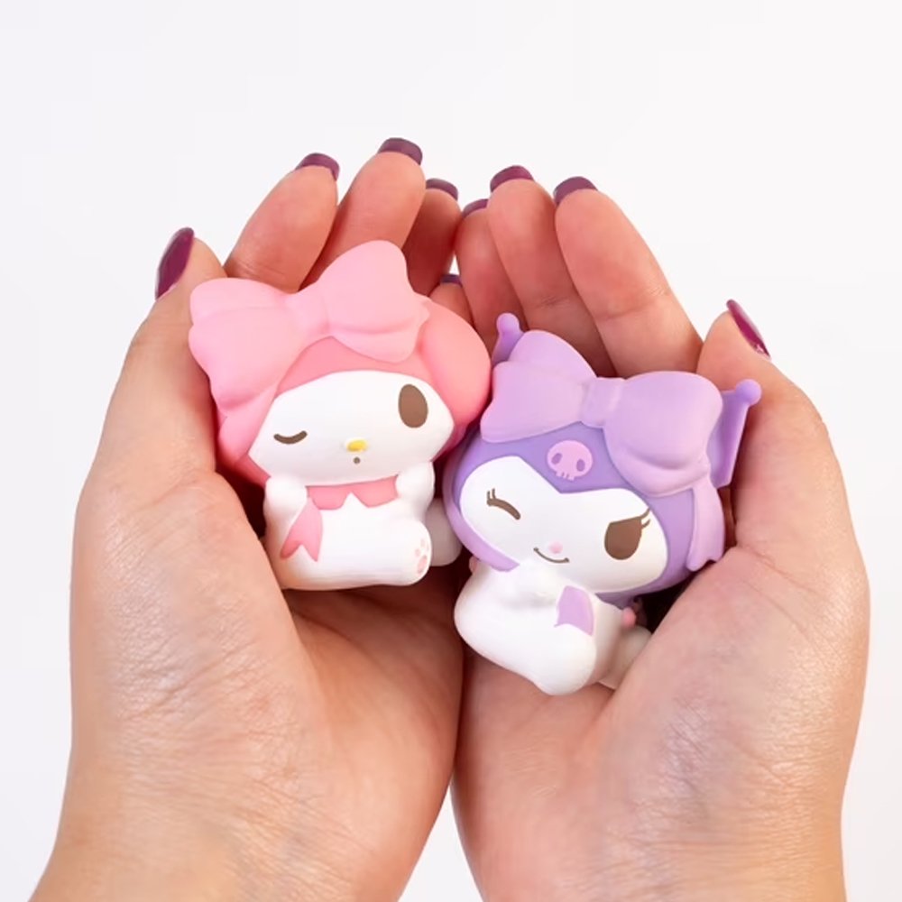 Officially licensed Sanrio Characters Water Squishy Surprise Capsule surrounded by collectible water-filled squishy figures including Hello Kitty, Kuromi, My Melody, Cinnamoroll, and Pompompurin wearing large bows