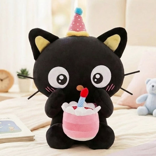 Officially licensed Sanrio Chococat celebration plush wearing a pink party hat and holding a mini plush birthday cake with a candle, featuring big embroidered white eyes and yellow ear accents