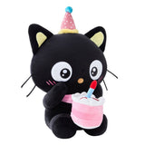 Officially licensed Sanrio Chococat celebration plush wearing a pink party hat and holding a mini plush birthday cake with a candle, featuring big embroidered white eyes and yellow ear accents
