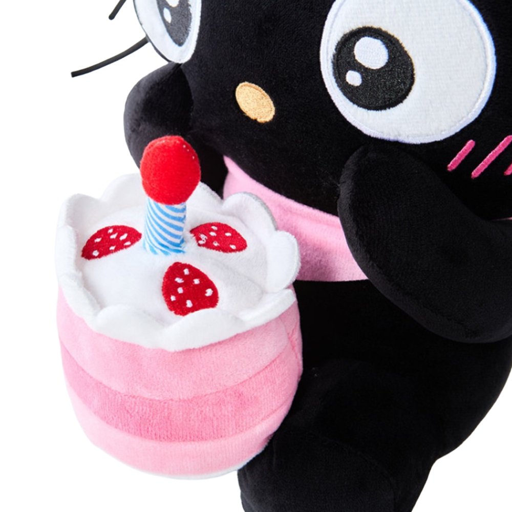 Officially licensed Sanrio Chococat celebration plush wearing a pink party hat and holding a mini plush birthday cake with a candle, featuring big embroidered white eyes and yellow ear accents
