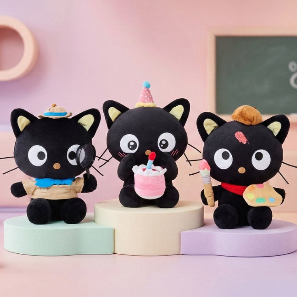 Officially licensed Sanrio Chococat celebration plush wearing a pink party hat and holding a mini plush birthday cake with a candle, featuring big embroidered white eyes and yellow ear accents