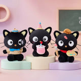 Officially licensed Sanrio Chococat celebration plush wearing a pink party hat and holding a mini plush birthday cake with a candle, featuring big embroidered white eyes and yellow ear accents