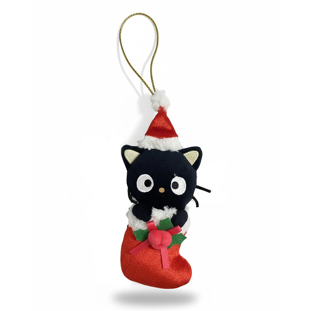 Sanrio Chococat is dressed for the season wearing a red Santa hat with a white pom-pom while sporting his signature red bow. He sits snugly in a red Christmas stocking adorned with green holly leaves and a decorative ribbon. Crafted from soft plush material, this ornament has a cozy, huggable feel. The attached gold cord loop makes it easy to hang on your Christmas tree.