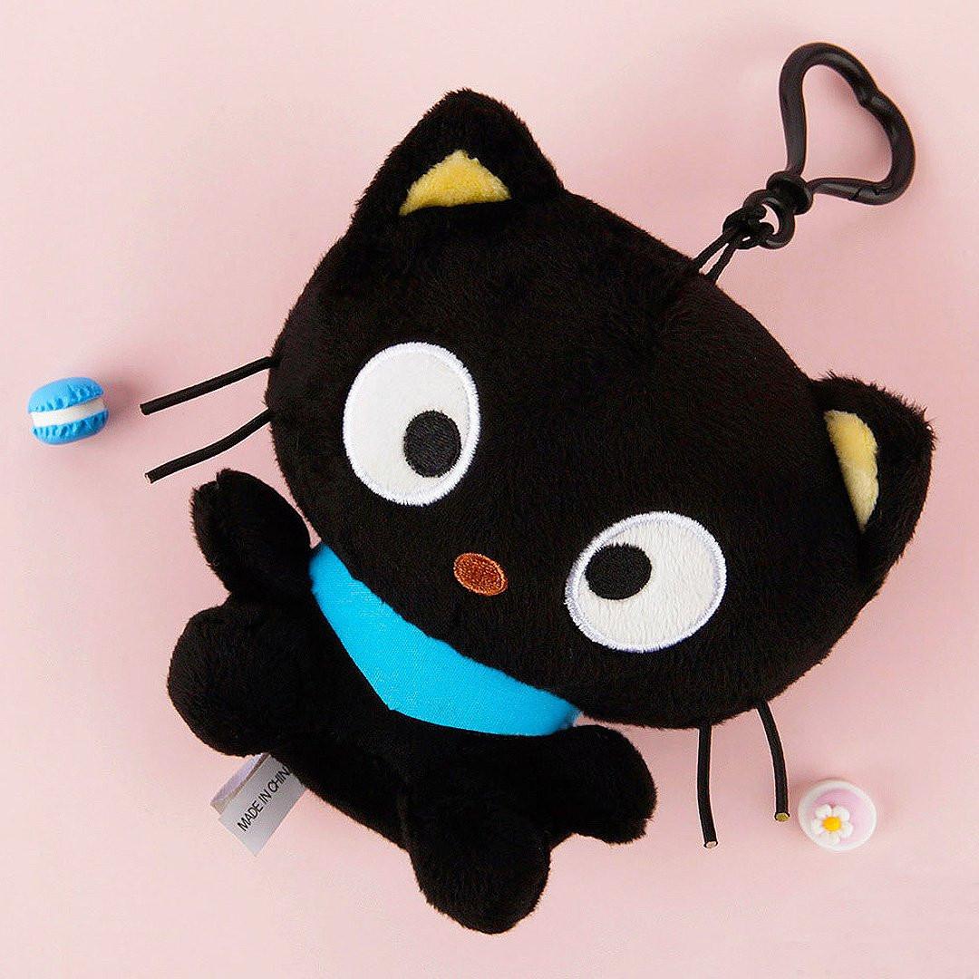 Officially licensed Sanrio Chococat mascot plush with signature blue scarf. This black cat stuffed animal features iconic big eyes and whiskers. Perfect for ornament , displaying, bag charm or gifting to Sanrio fans of all ages.