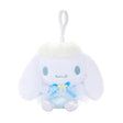 An officially licensed Sanrio Cinnamoroll plush keychain featuring the character in a blue ballerina tutu and polka-dot bodice with a yellow star detail. The plush includes fluffy white head trim, angel wings, and a white plastic clip for easy attachment.
