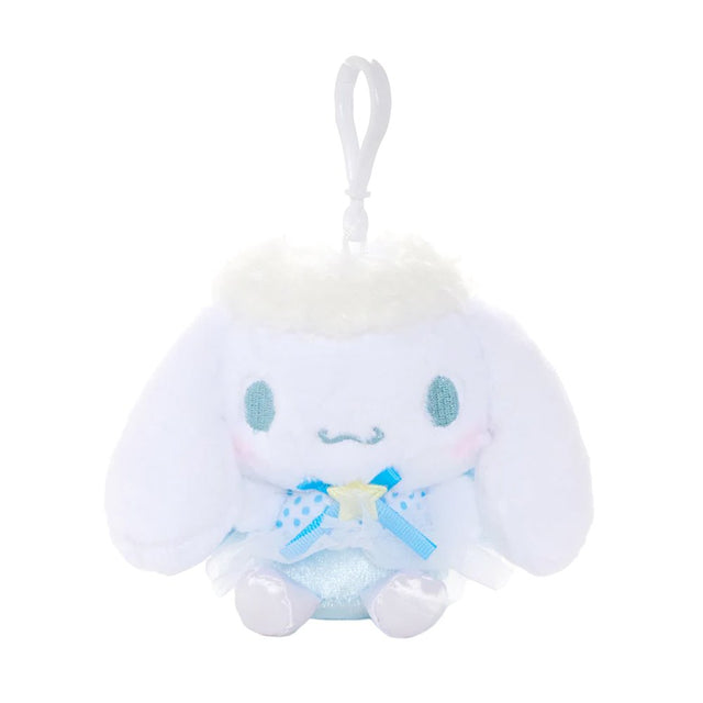 An officially licensed Sanrio Cinnamoroll plush keychain featuring the character in a blue ballerina tutu and polka-dot bodice with a yellow star detail. The plush includes fluffy white head trim, angel wings, and a white plastic clip for easy attachment.
