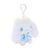 An officially licensed Sanrio Cinnamoroll plush keychain featuring the character in a blue ballerina tutu and polka-dot bodice with a yellow star detail. The plush includes fluffy white head trim, angel wings, and a white plastic clip for easy attachment.
