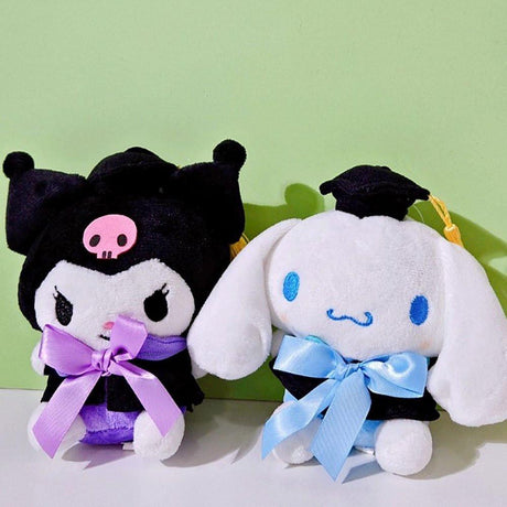 An officially licensed Sanrio Cinnamoroll plush toy dressed in a black graduation cap with a gold tassel and a matching gown featuring a large light blue bow