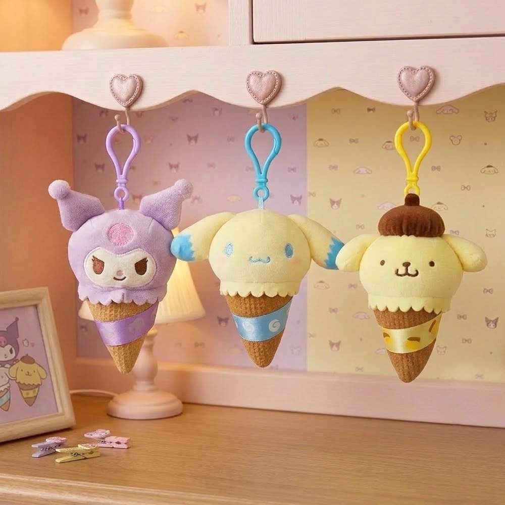 A collection of officially licensed Sanrio plush keychains featuring Kuromi, Cinnamoroll, and Pompompurin as ice cream cones with colorful scoops, textured cones, and matching plastic clips.