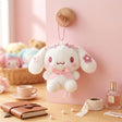 Officially licensed Sanrio Cinnamoroll pink tone plush keychain styled in dreamy pastel pink and soft white hues with color-matched embroidered features, dangling from a ball chain