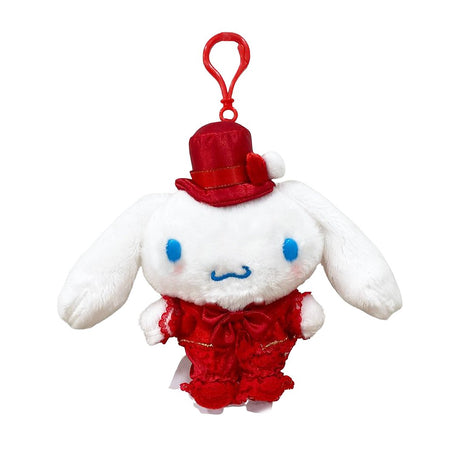 Officially licensed by Cinnamoroll Plush keychain in a red dress with hat on a white background. He’s perfect for ornament , displaying, or gifting Christmas to Sanrio fans of all ages.