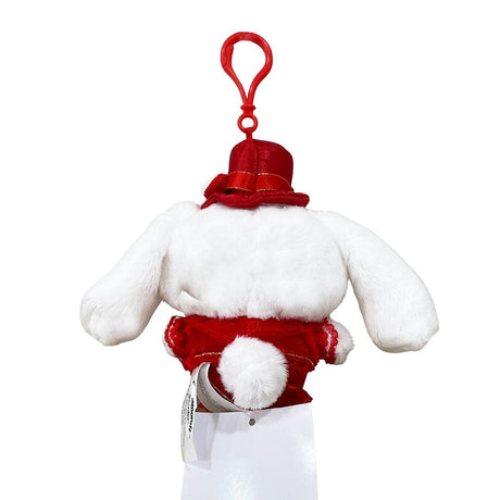 Officially licensed by Cinnamoroll Plush keychain in a red dress with hat on a white background. He’s perfect for cuddling, displaying, or gifting Christmas to Sanrio fans of all ages.