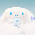 Magical Cinnamoroll Snow Angel plush sitting on soft clouds against a light blue background, creating a serene winter scene