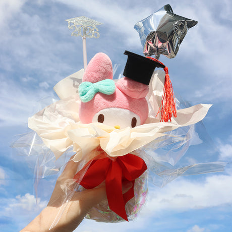 An officially licensed Class of 2026 Sanrio graduation gift set featuring My Melody wearing black graduation cap. The character plush is arranged like a bouquet with silver star balloons and "2026" decorations.