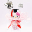 An officially licensed Class of 2026 Sanrio graduation gift set featuring six popular plush characters, Hello Kitty, My Melody, Cinnamoroll, Kuromi, Pompompurin, and Pochacco wearing black graduation caps. The characters are arranged like a bouquet with silver star balloons and "Congrats Grad" decorations.