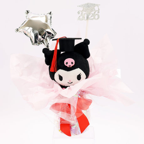 An officially licensed Class of 2026 Sanrio graduation gift set featuring six popular plush characters, Hello Kitty, My Melody, Cinnamoroll, Kuromi, Pompompurin, and Pochacco wearing black graduation caps. The characters are arranged like a bouquet with silver star balloons and "Congrats Grad" decorations.