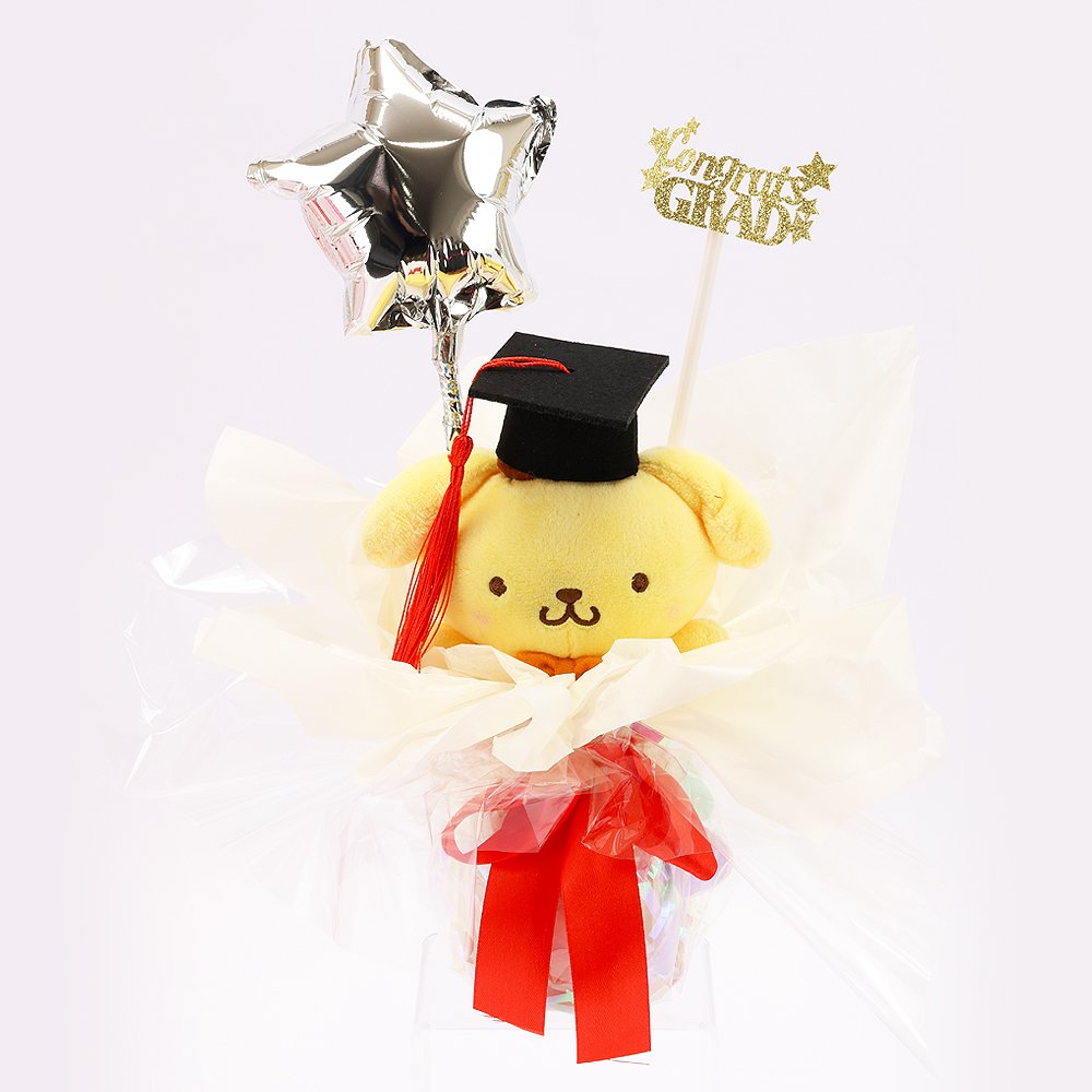 An officially licensed Class of 2026 Sanrio graduation gift set featuring six popular plush characters, Hello Kitty, My Melody, Cinnamoroll, Kuromi, Pompompurin, and Pochacco wearing black graduation caps. The characters are arranged like a bouquet with silver star balloons and "Congrats Grad" decorations.