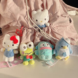 Sanrio Hello Kitty, Keroppi, Hangyodon, Tuxedosam, Dear Daniel plush toys in front of a pink backpack. Ideal as collectible bag charms and accessories.