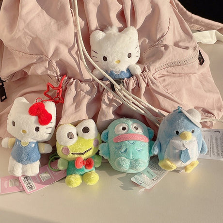 Sanrio Hello Kitty, Keroppi, Hangyodon, Tuxedosam, Dear Daniel plush toys in front of a pink backpack. Ideal as collectible bag charms and accessories.