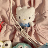 Sanrio official plush keychains from the school uniform series. Dear Daniel in mauve  backpack pocket, wearing a blue . Ideal as collectible bag charms and accessories.