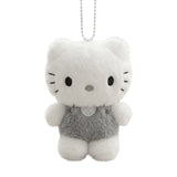 A fluffy white Dear Daniel plush doll keychain wearing textured grey overalls with a heart patch