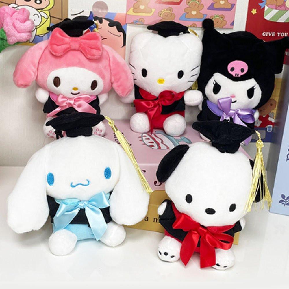 An officially licensed Sanrio Hello Kitty, My Melody, Cinnamoroll, Kuromi, and Pochacco plush toys dressed in a black graduation cap with a gold tassel and a matching gown featuring a large red bow