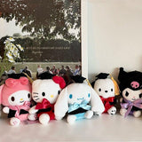 An officially licensed Sanrio Hello Kitty, My Melody, Cinnamoroll, Kuromi, and Pochacco plush toys dressed in a black graduation cap with a gold tassel and a matching gown featuring a large red bow