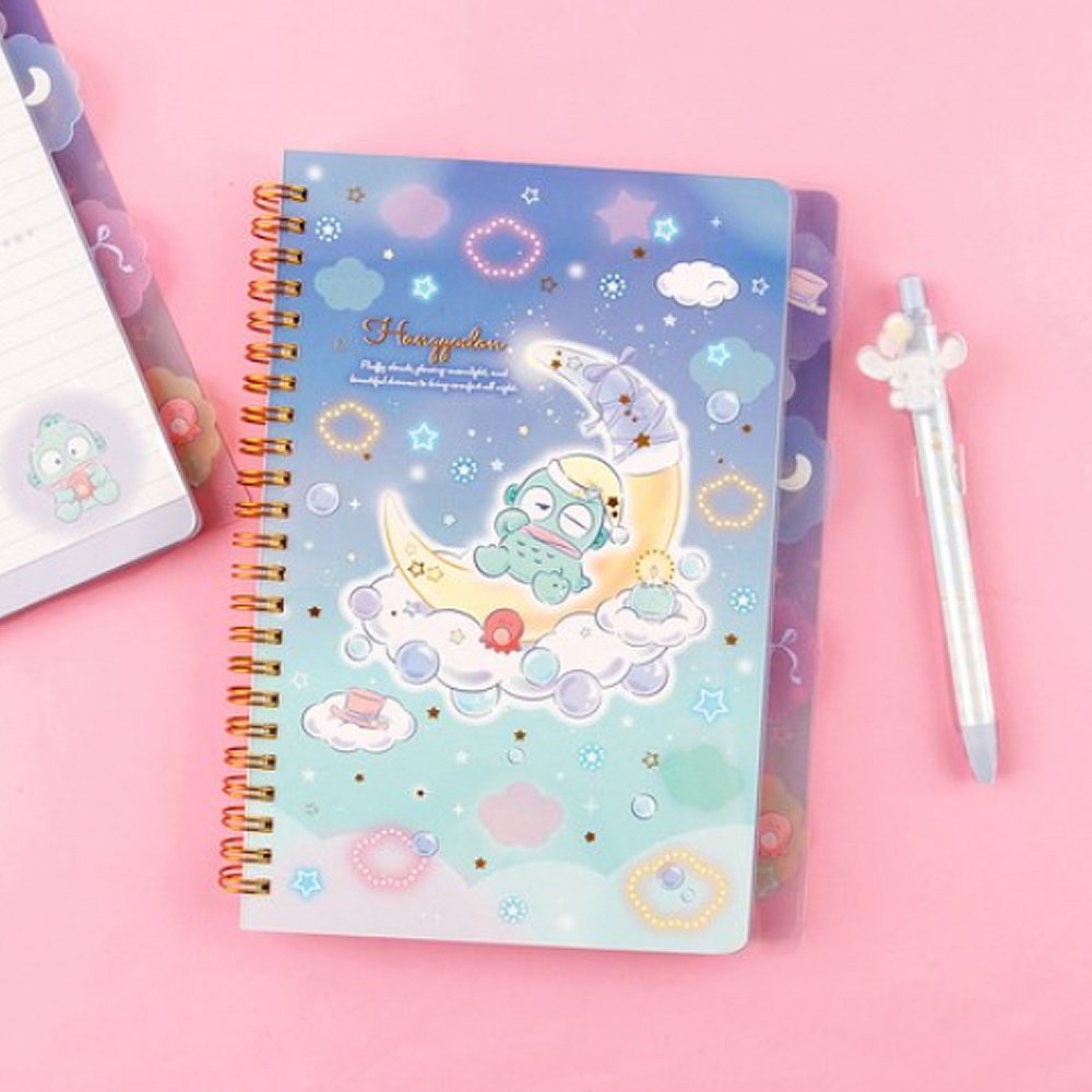 An officially licensed Sanrio Hangyodon spiral-bound notebook, featuring a glitter finish with gold stars and an illustration of Hangyodon. Includes four distinct, colorful dividers and five different interior page designs.