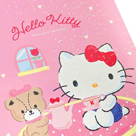 A soft pink, officially licensed Hello Kitty spiral lined notebook featuring Hello Kitty having a tea party with her teddy bear.