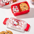 Red Sanrio Hello Kitty bento box with cookies and candies, featuring Hello Kitty design on a white background. Perfect bring your meal at school, office ,camping or picnic 