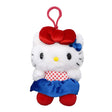 An officially licensed Hello Kitty Big Ribbon plush keychain wearing a red and white polka dot top with a blue satin skirt and red shoes.
