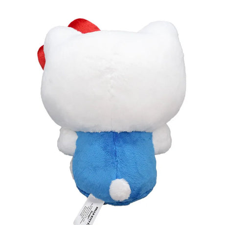 Officially licensed Hello Kitty plush toy sitting and holding a large red plush bow, featuring her classic white fur, yellow nose, and signature red ear bow.