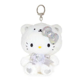 An officially licensed Sanrio Hello Kitty April birthstone plush keychain clip wearing a white bear hood, an iridescent silver bow, and a silver ribbon with a heart-shaped faux gemstone.