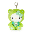 An officially licensed Sanrio Hello Kitty August birthstone plush keychain clip wearing a lime-green bear hood, a metallic pale green bow, and a teal ribbon with a heart-shaped faux gemstone.