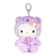 An officially licensed Sanrio Hello Kitty February birthstone plush keychain clip wearing a pastel purple bear hood, a pink bow, and a pink ribbon with a heart-shaped faux gemstone.