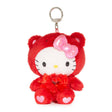 An officially licensed Sanrio Hello Kitty January birthstone plush keychain clip wearing a red garnet-themed hood, a pink bow, and a red ribbon with a heart gem.
