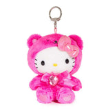 An officially licensed Sanrio Hello Kitty July birthstone plush keychain clip wearing a hot pink bear hood, a metallic pink bow, and a pink ribbon with a heart-shaped faux gemstone.