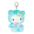 An officially licensed Sanrio Hello Kitty May birthstone plush keychain clip wearing a mint-green bear hood, an iridescent pale green bow, and a pink ribbon with a heart-shaped faux gemstone.