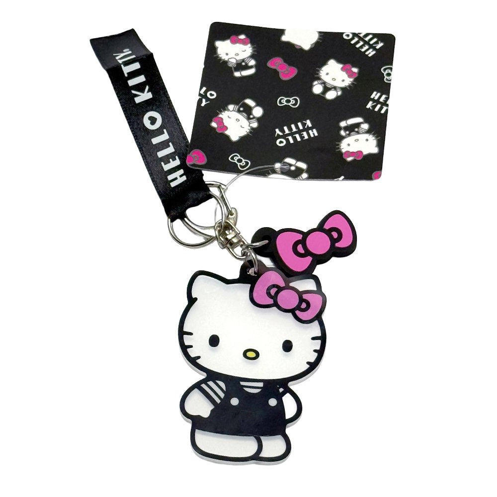 An officially licensed Sanrio Hello Kitty keychain featuring a full-body charm of Hello Kitty in a black outfit and pink bow, complete with a matching pink bow charm and a black fabric tag.