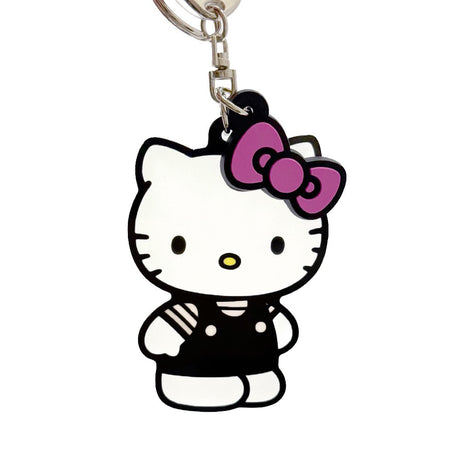 An officially licensed Sanrio Hello Kitty keychain featuring a full-body charm of Hello Kitty in a black outfit and pink bow, complete with a matching pink bow charm and a black fabric tag.